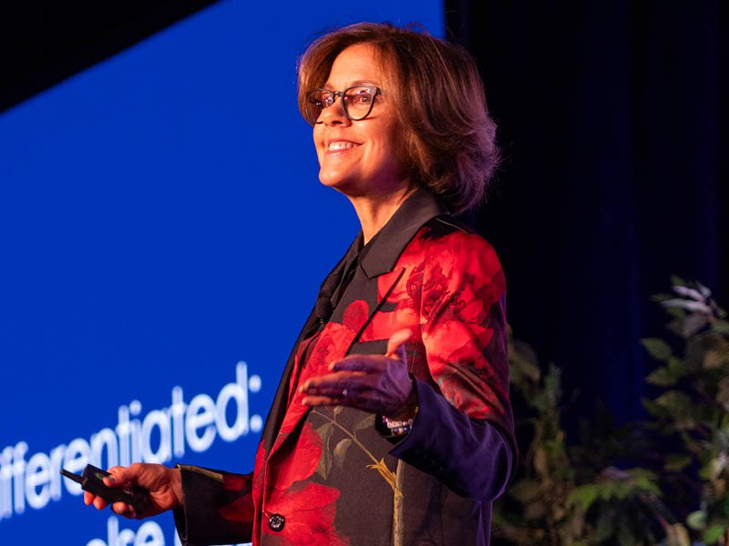 MarketingProfs' Chief Content Officer, Ann Handley, smiling on stage at B2B Forum 2024